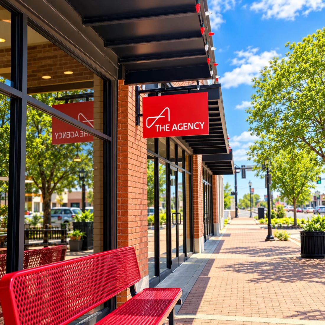 The red The Agency sign hanging over the sidewalk outside our downtown Edmond office